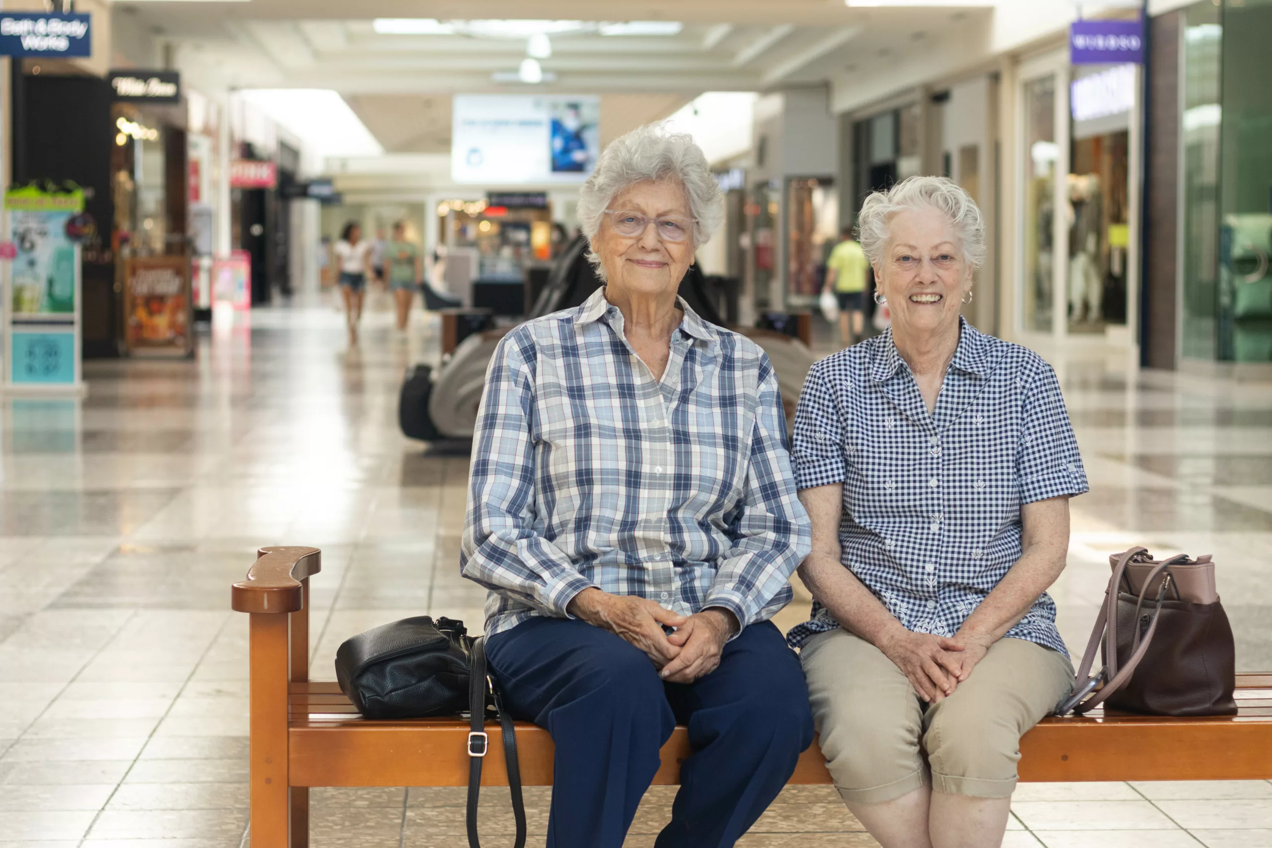 Two senior women sitting on a bench in the Columbia, Mall.