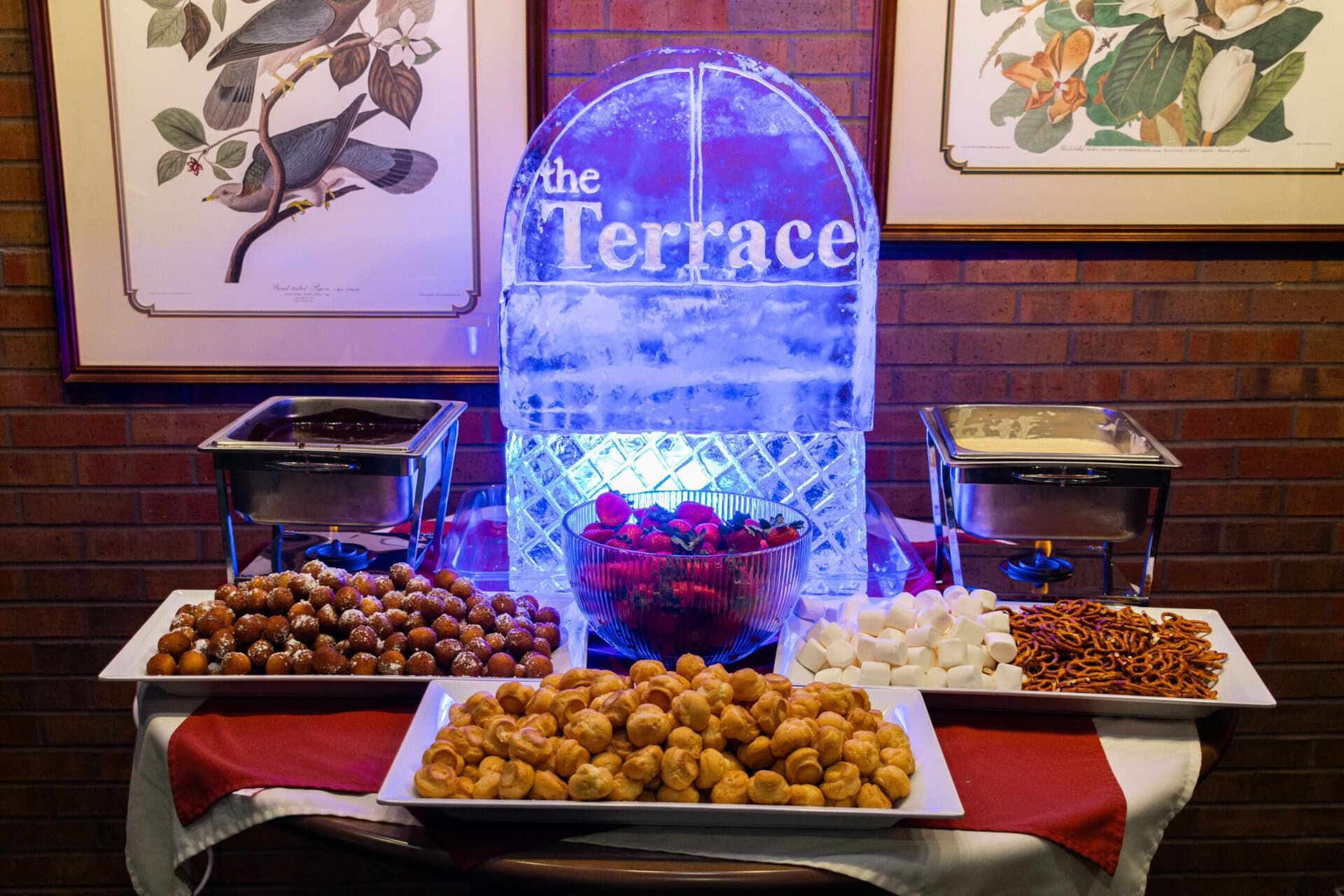 The Terrace Ice Sculpture with three plates of food around 